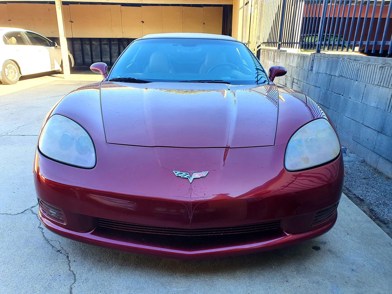 A Red Chevrolet Corvette Car With Oxidized Headlights