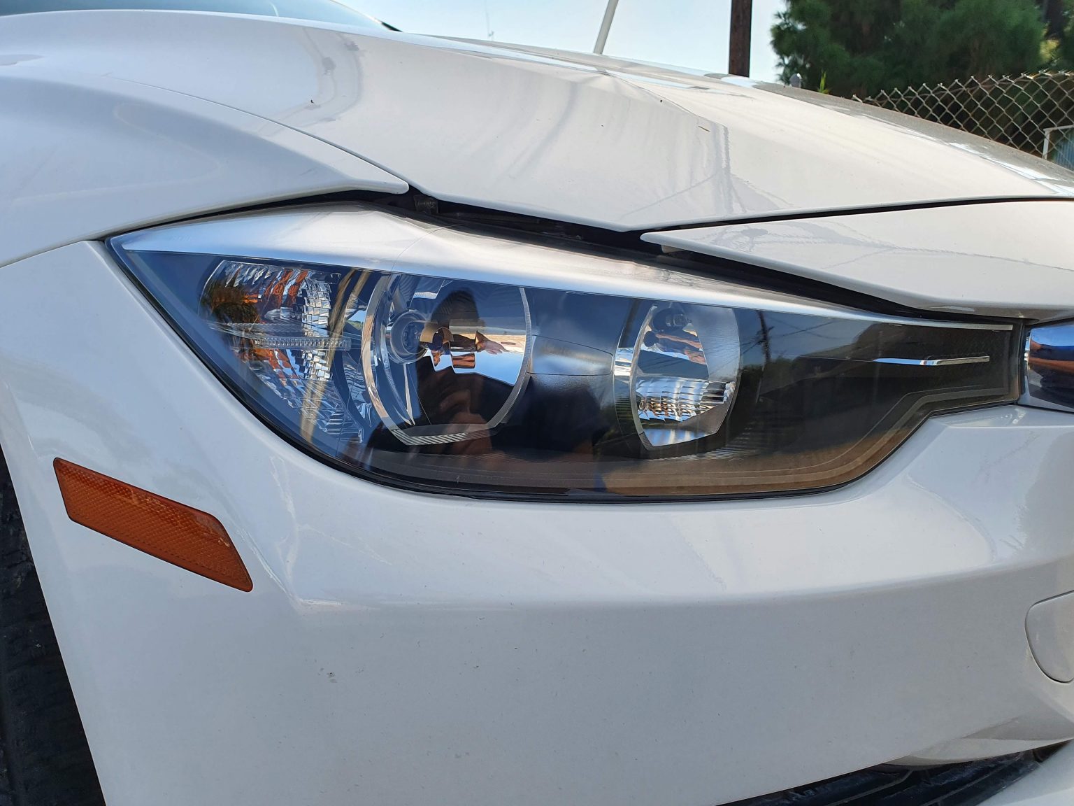 The Front Headlights of a White Car