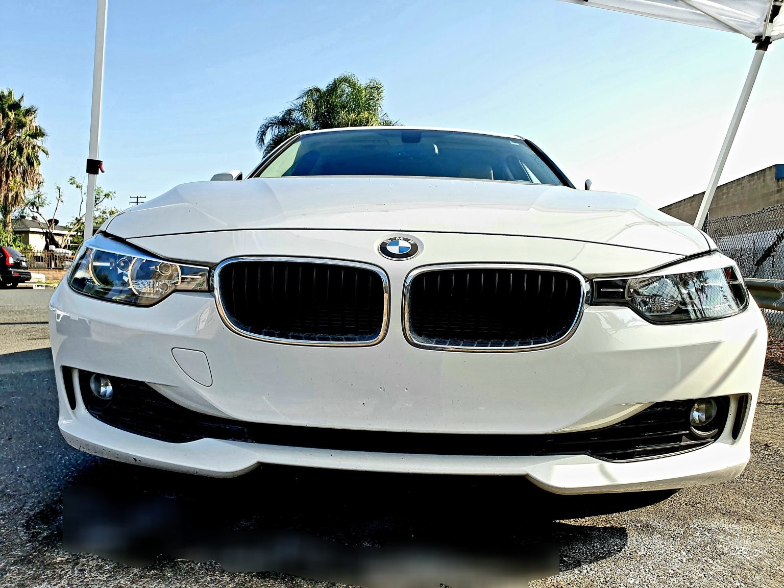 The Front of a White Color BMW Car