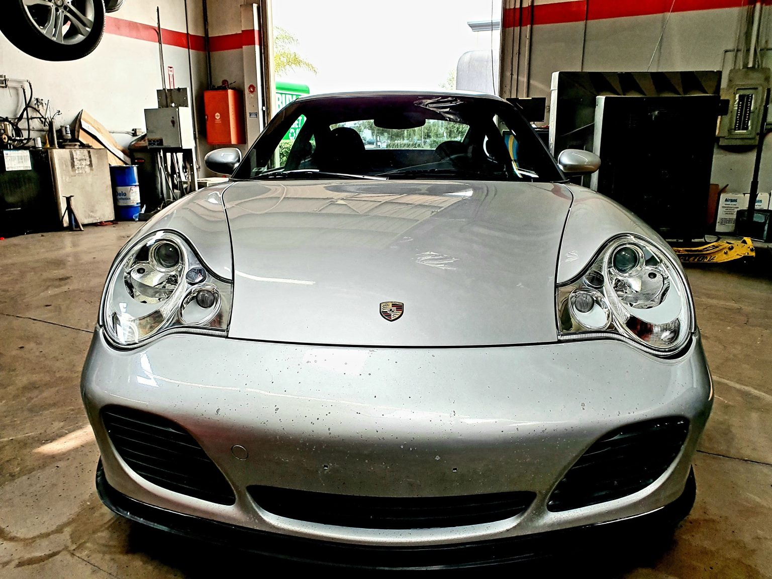 A Silver Color Car With Brand New Headlights