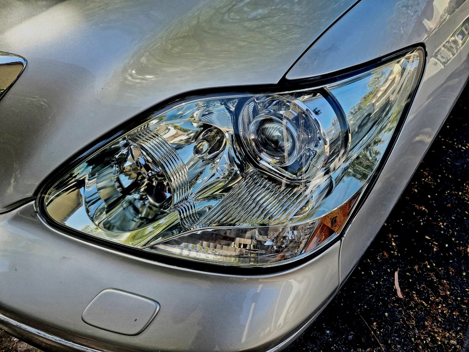 The Side Headlights of a Grey Color Car