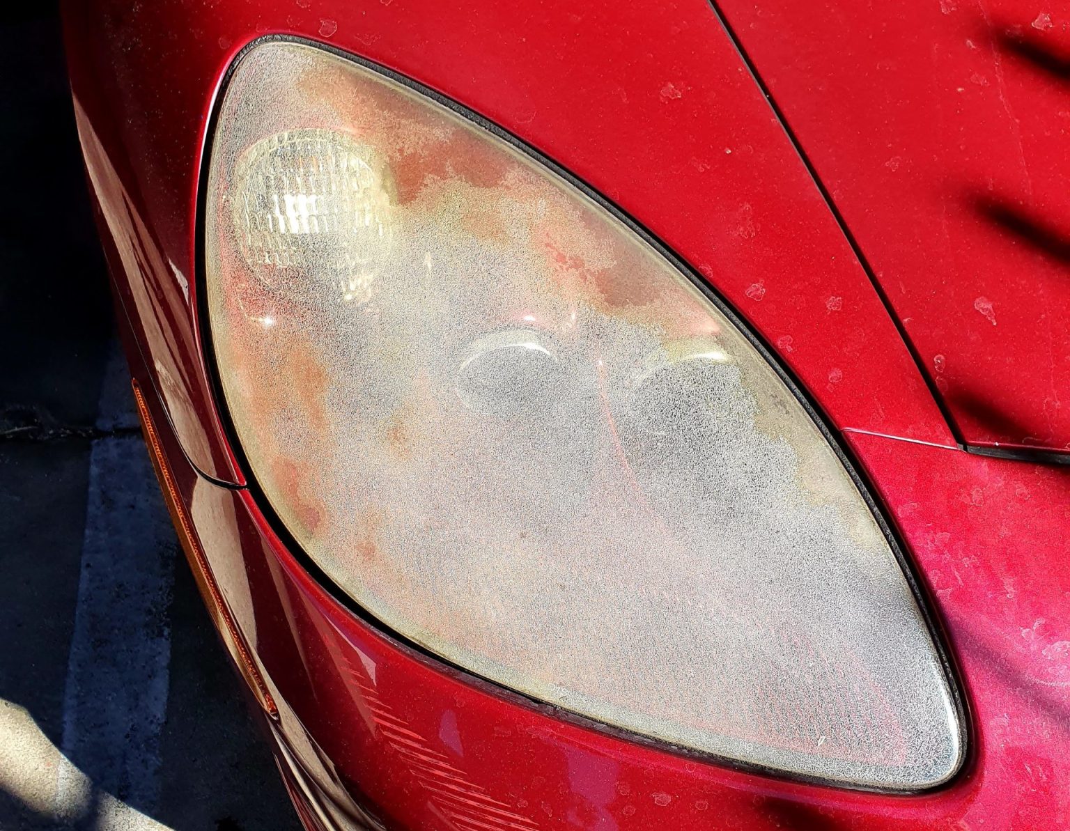 Front Scaled Headlights of a Red Color Car One