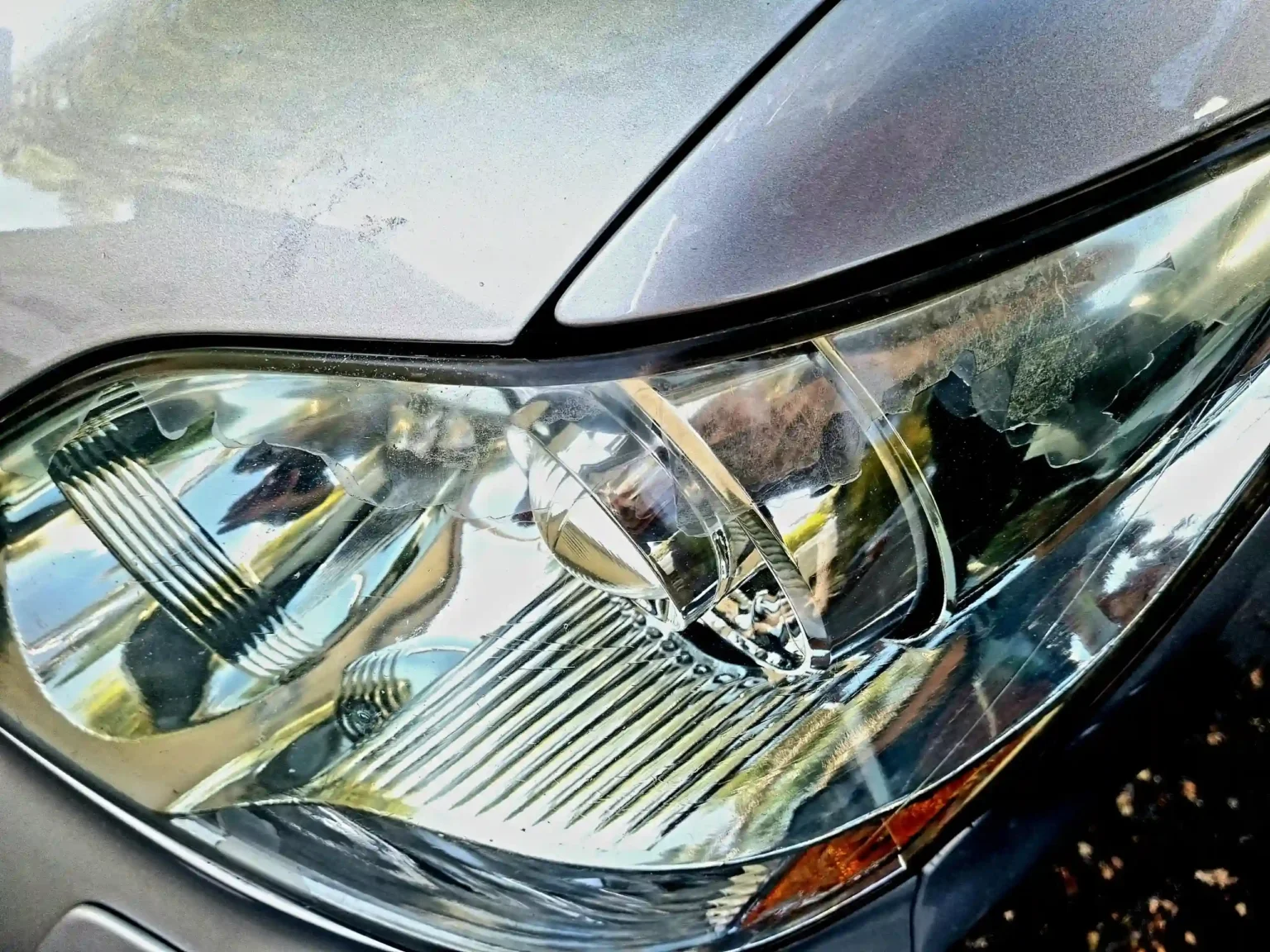 An Oxidized Front Headlights of a Grey Car